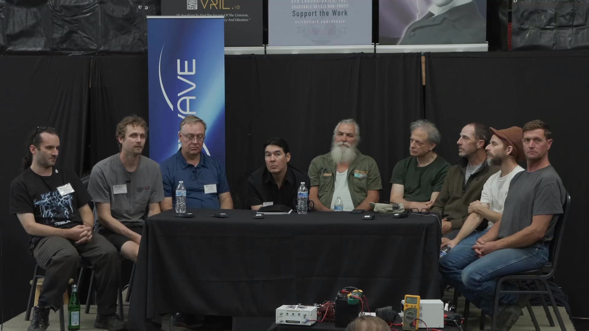 The full panel with demonstration hardware and test equipment on the bench in front of the stage