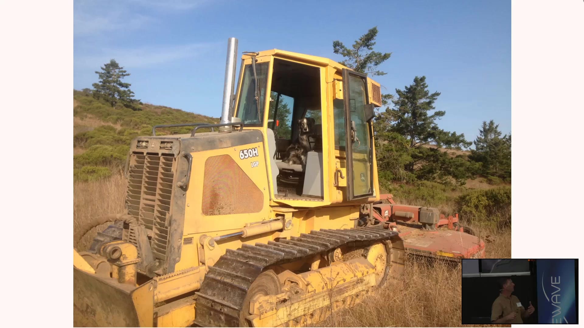 Mechanical brush management: a tracked dozer with a mower working dry brush